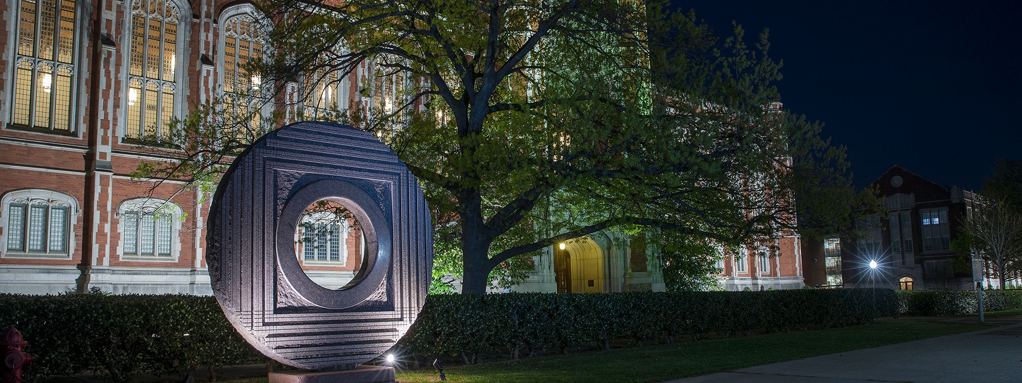 Bizzel Memorial Library lit up at night time. Price Hall is visible in the background.