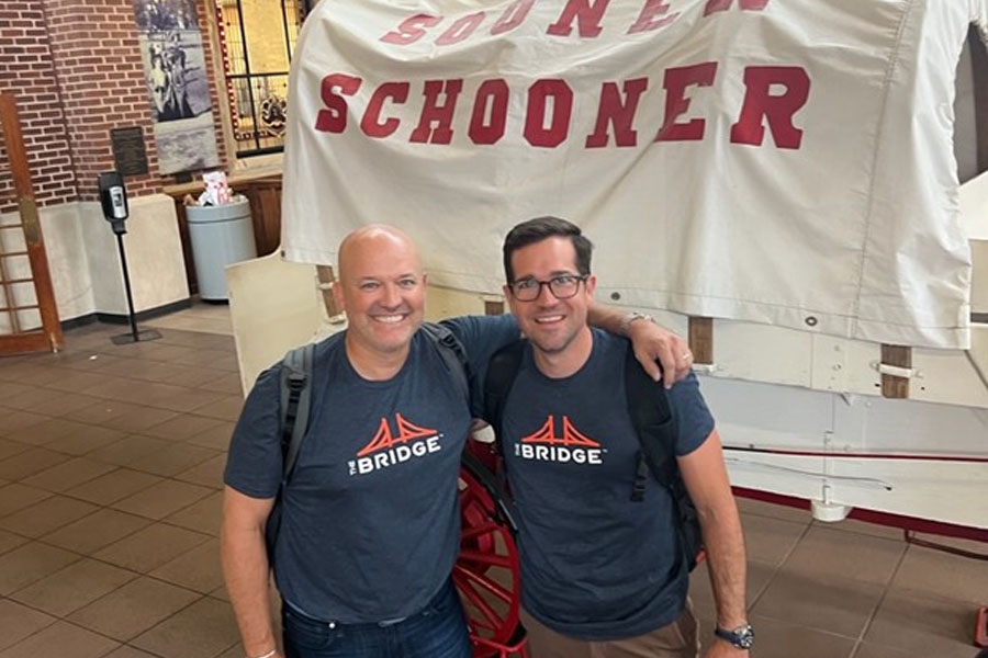 Robby Riggs and associate standing near the Sooner Schooner at the Oklahoma Memorial Union.