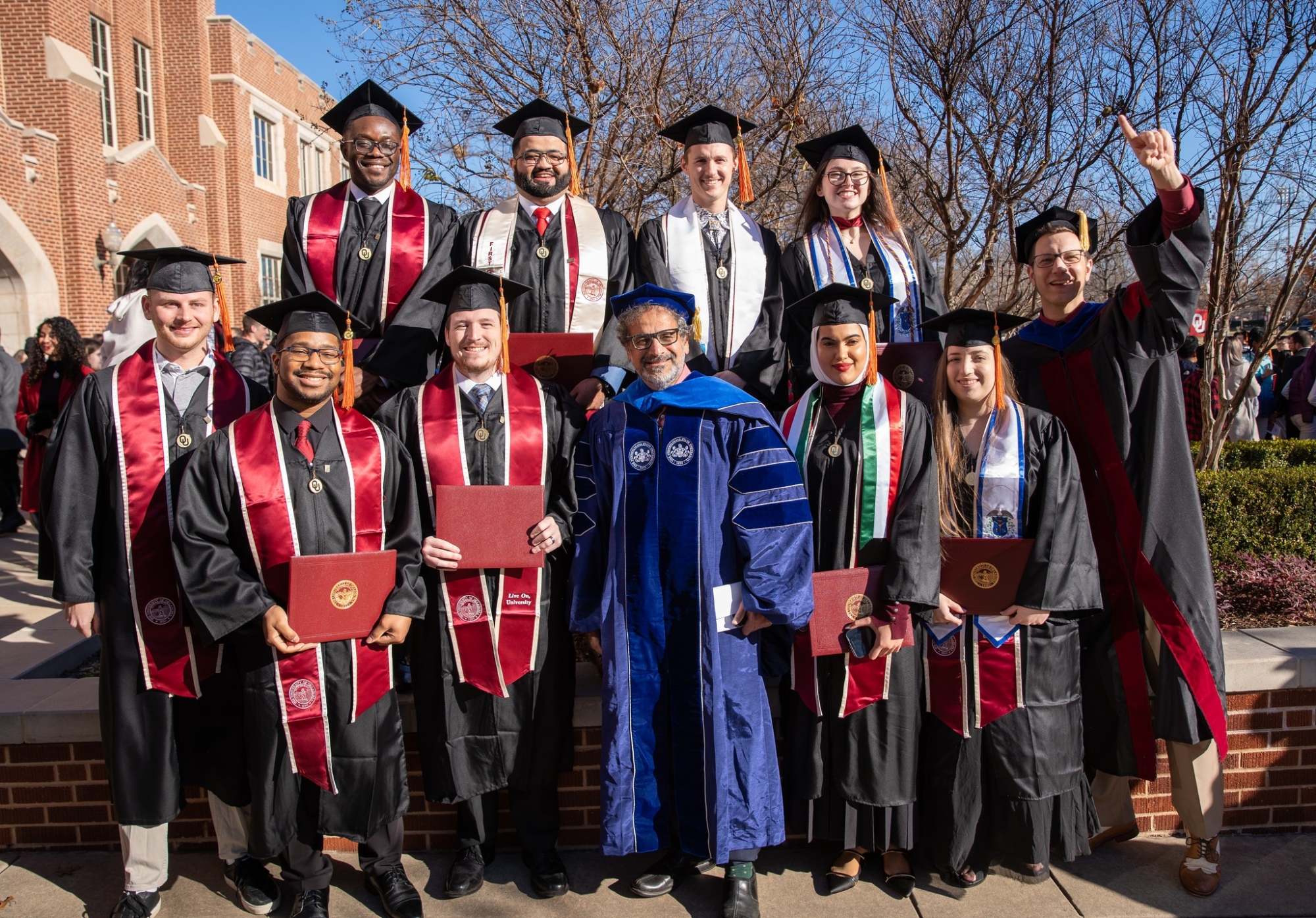 Group of OU graduates with OU faculty member