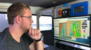 Meteorology graduate student Alec Prosser operating the radar during the passage of hurricane Dorian off the Florida coast in 2019
