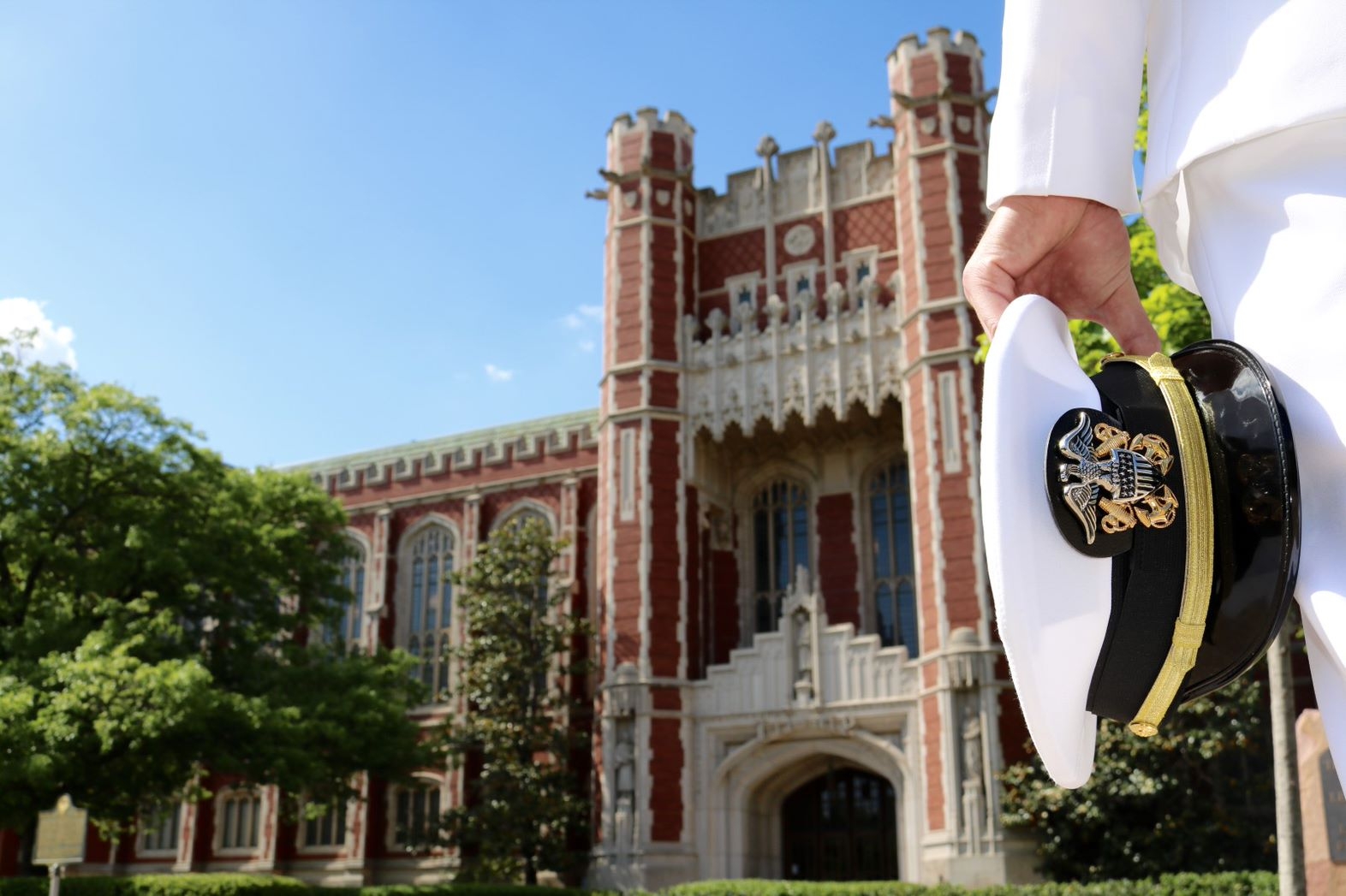 NROTC member standing in front of the Bizzell in their unifrom.