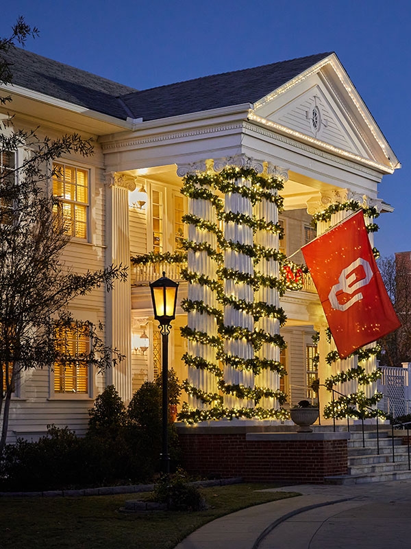 Boyd House decorated for the holidays, with Whitehand Hall in the background.