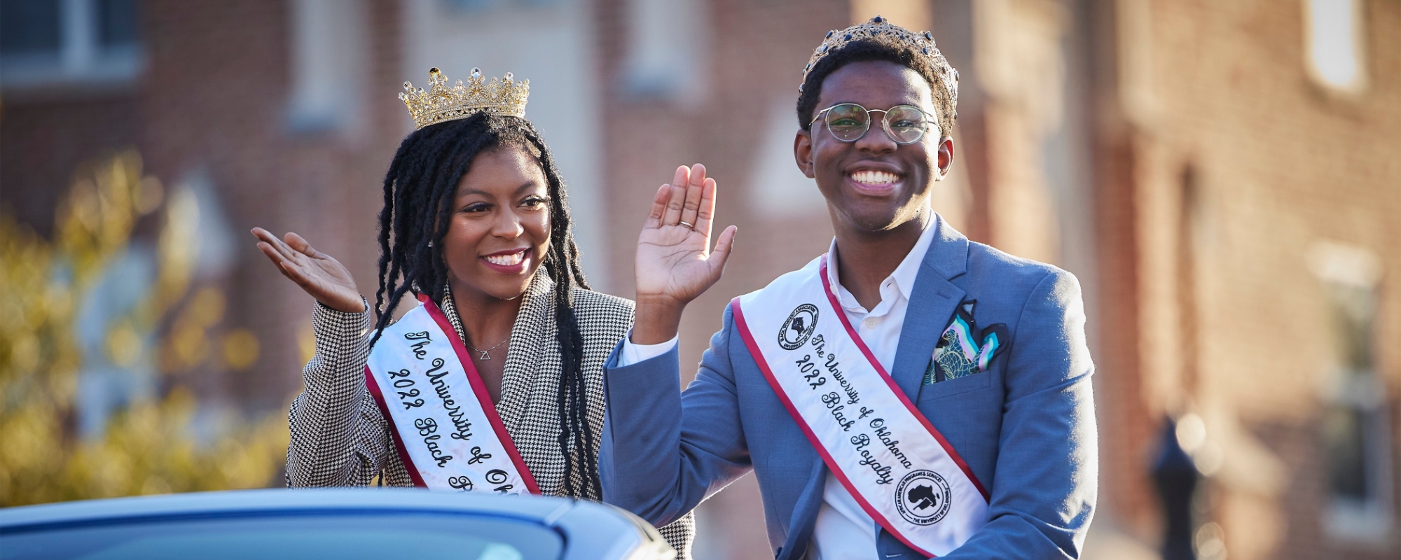 OU 2022 Black Student Royalty waving from a vehicle in the homecoming parade. 