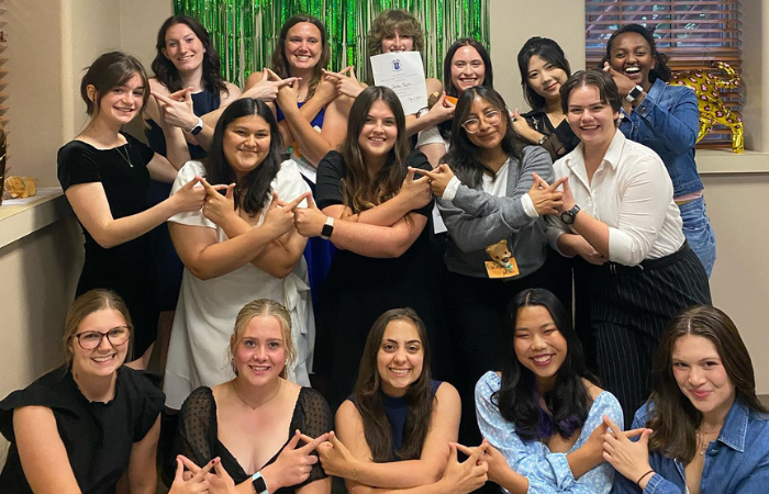 Alpha Sigma Kappa members pose for a group photo. 