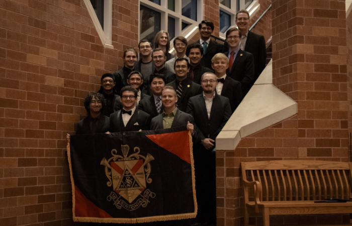 Phi Mu Alpha members pose for a group photo. 