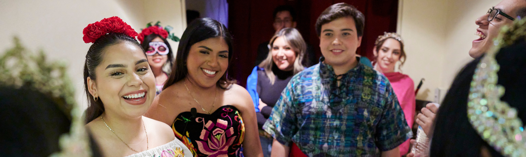 Students smiling and laughing backstage at the OU Hispanic Royalty Pageant.