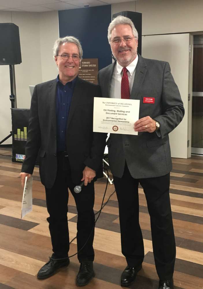 John Sarantakos (right) of Printing, Mailing and Document Services accepts the Environmental Concerns Committee's Stewardship Award for a Department. 