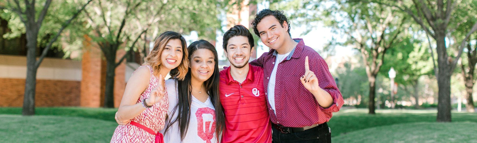 Four O U students posing for a photo on campus.