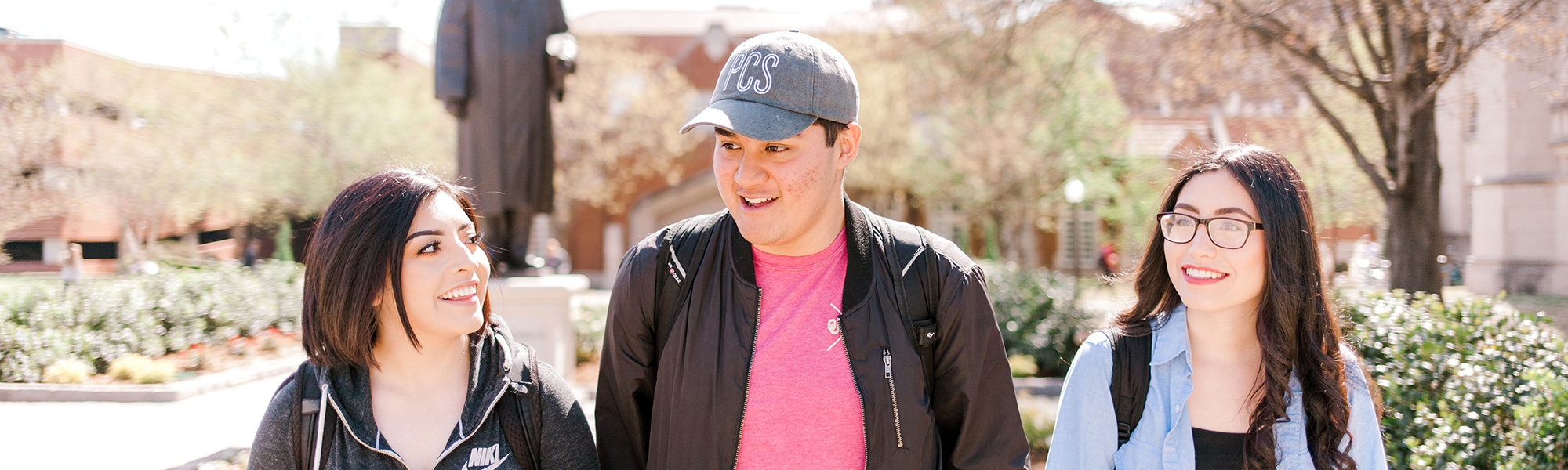 Three students walking outside at the OU Norman campus.