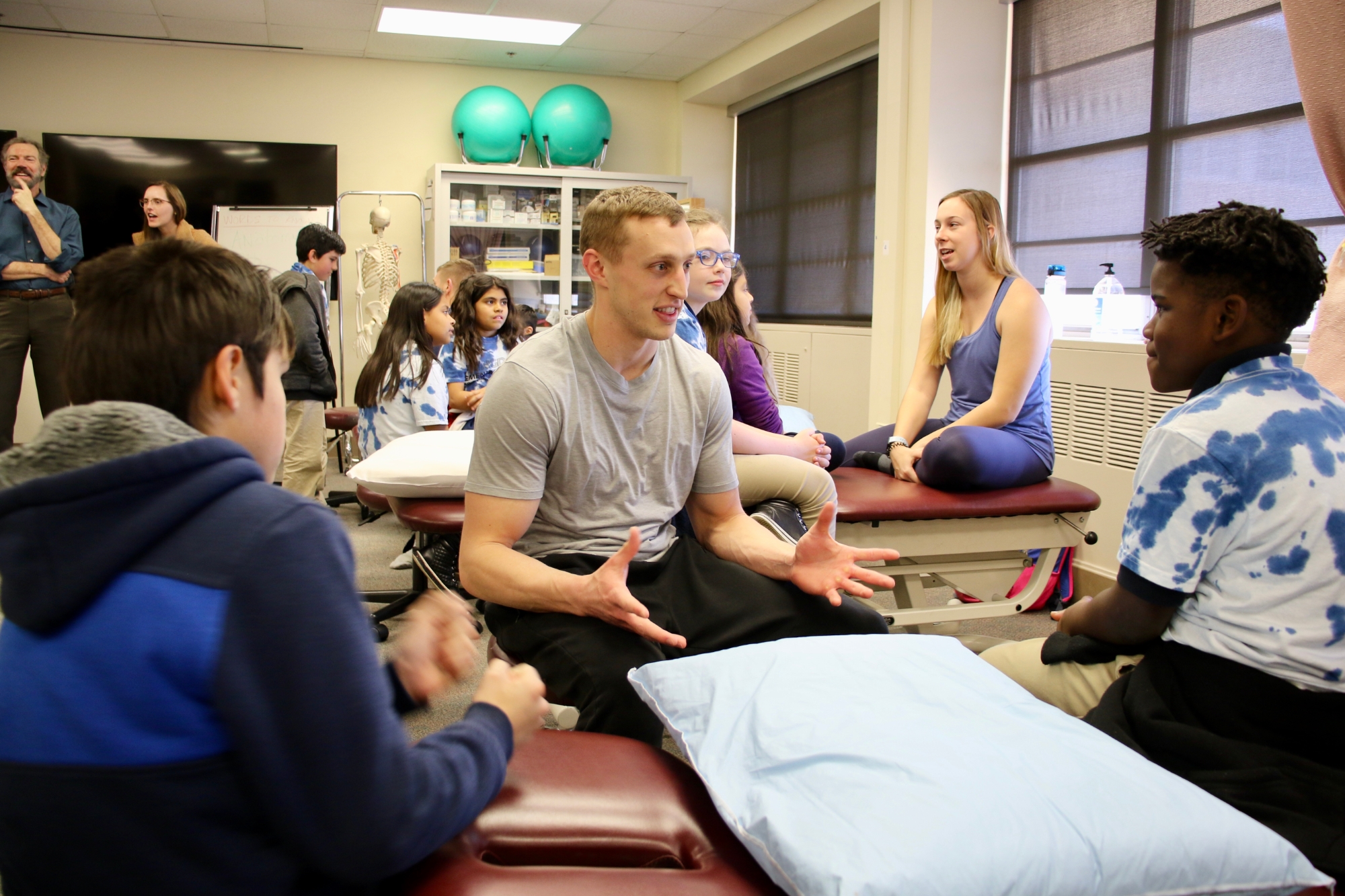 Physical therapy students talking to youth