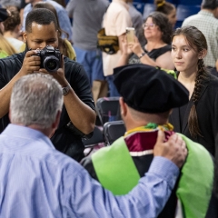 A photographer takes photos of graduating seniors at OU-Tulsa Convocation