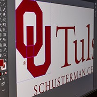 A screen displays image editing software and the OU-Tulsa logo 