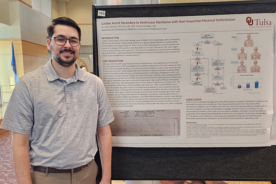 OU Tulsa medical research student in front of their research.