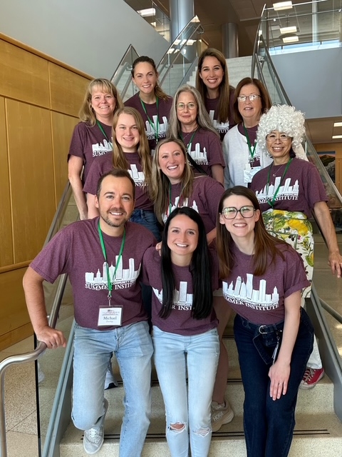 Group of pediatric residents posing on a staircase for group photo.