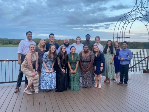 A whole class of students smiling and posing together for a group photo.