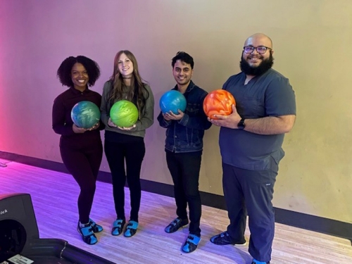 Students holding bowling balls.