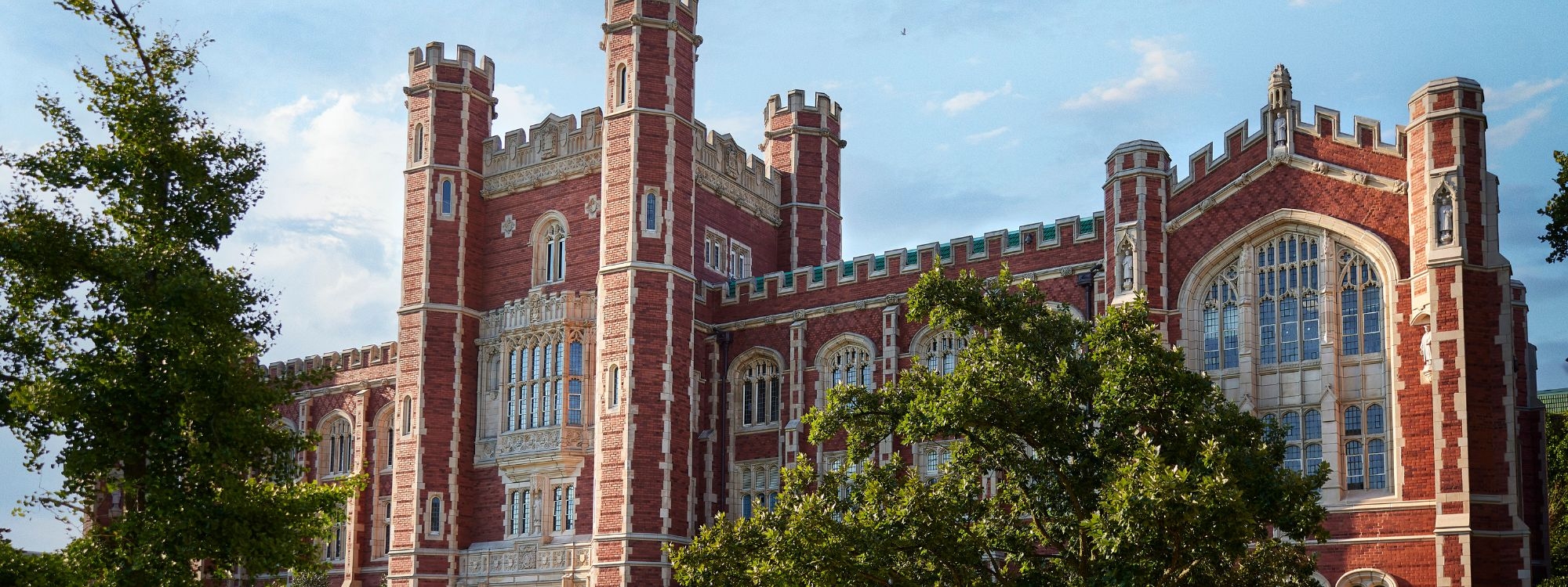 Evans Hall with trees and sky.