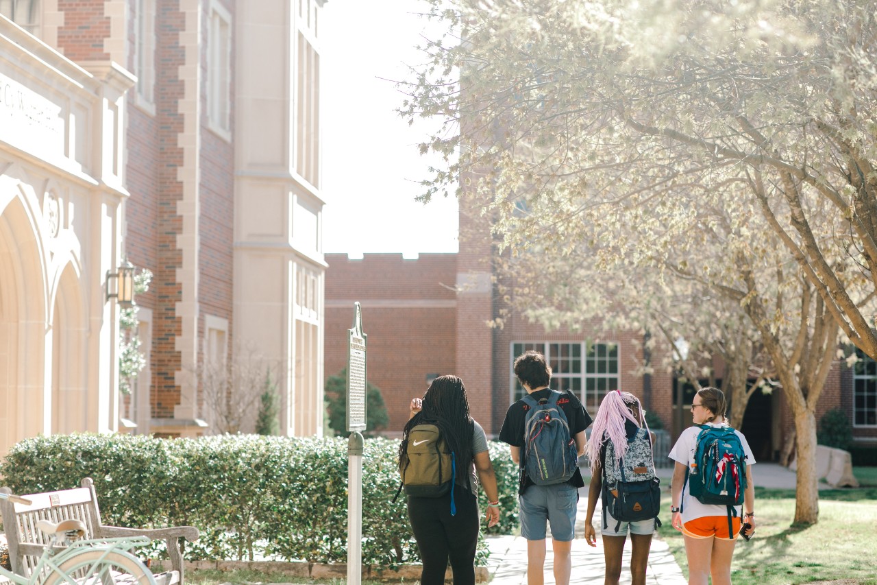 four-students-walking-on-campus