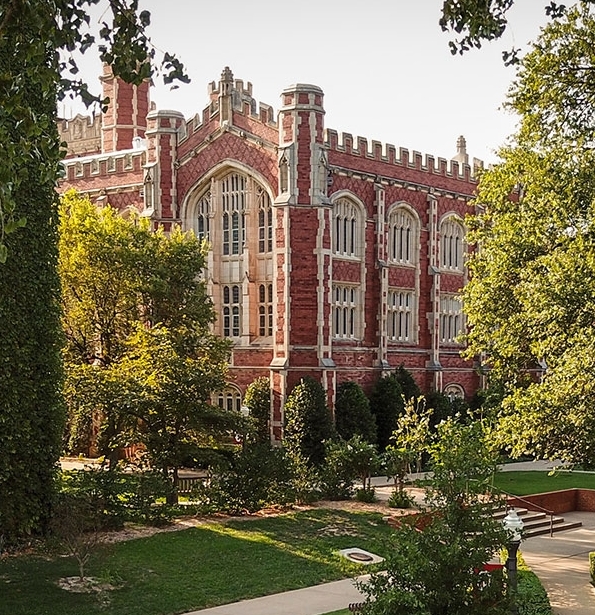Evans Hall with trees and sidewalks.