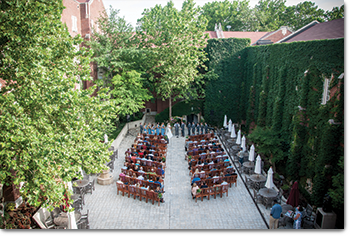 image of 100 people seated in the outdoor courtyard