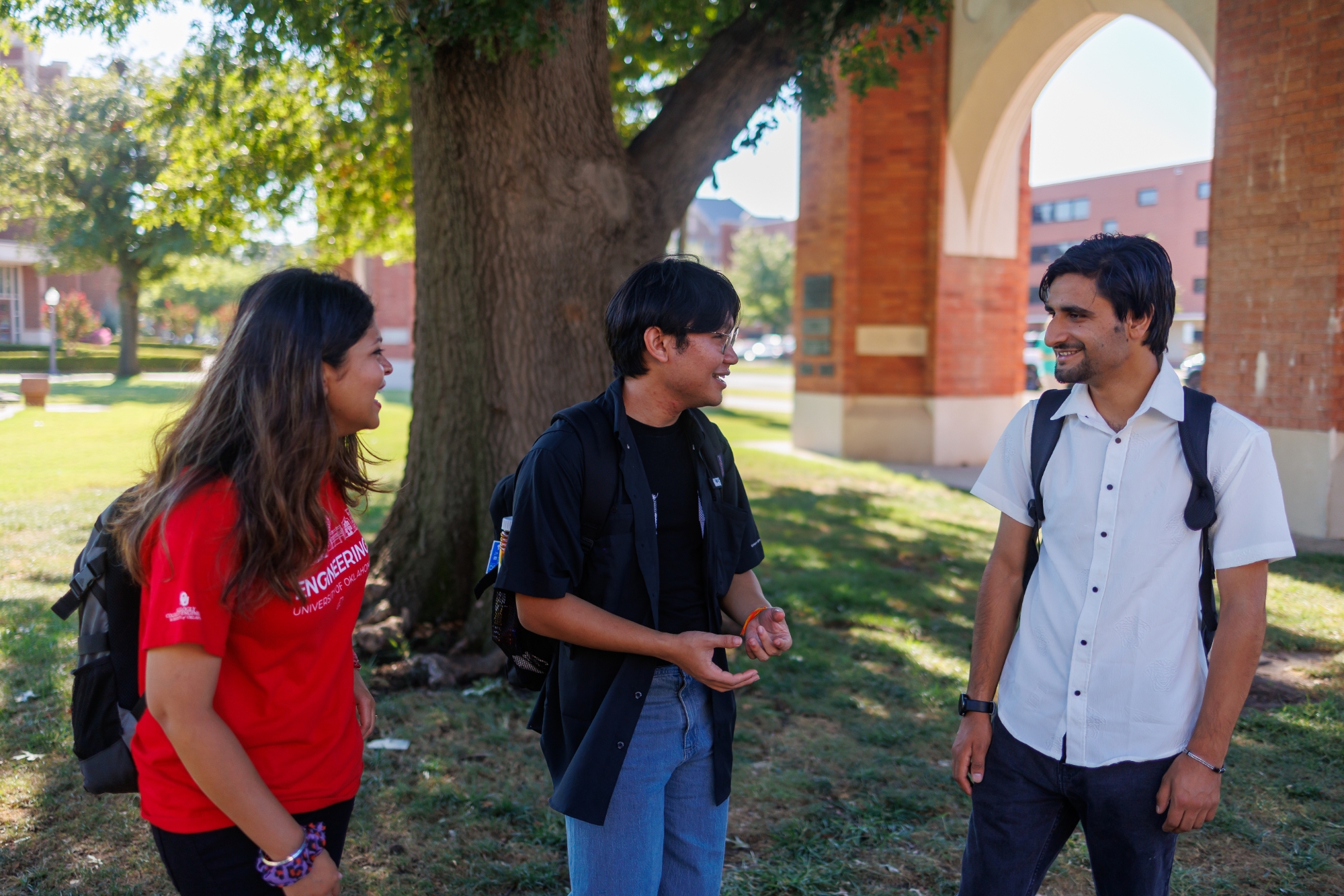 Three students talking outside.