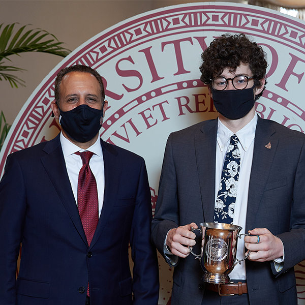 Carson Ball poses with President Harroz, both wearing COVID masks
