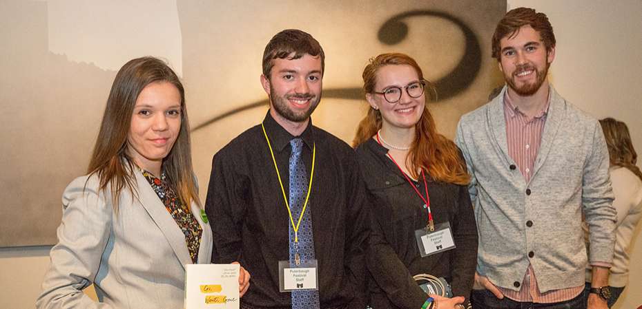 Four world literature interns at a conference.